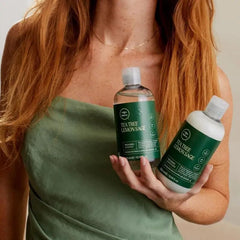 Tea Tree bottle in hand showing 10.14 fl oz size for scale