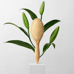 The Hair Edit brush held in hand to show scale and easy maneuverability benefit