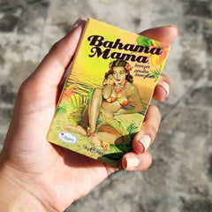theBalm Bahama Mama compact held in hand to show scale and travel-ready convenience benefit