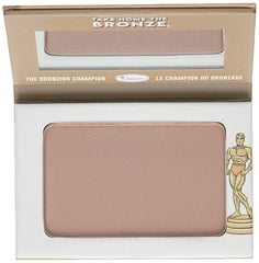 theBalm Oliver next to brush showing compact size and travel-friendly packaging
