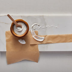 Thymes Kimono Rose beside a measuring object showing 8.25 fl oz scale