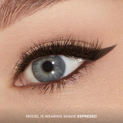Too Faced liner held in hand showing scale and travel-friendly portability