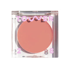 Tower 28 front packaging showing compact tinted balm and rosy nude shade benefit