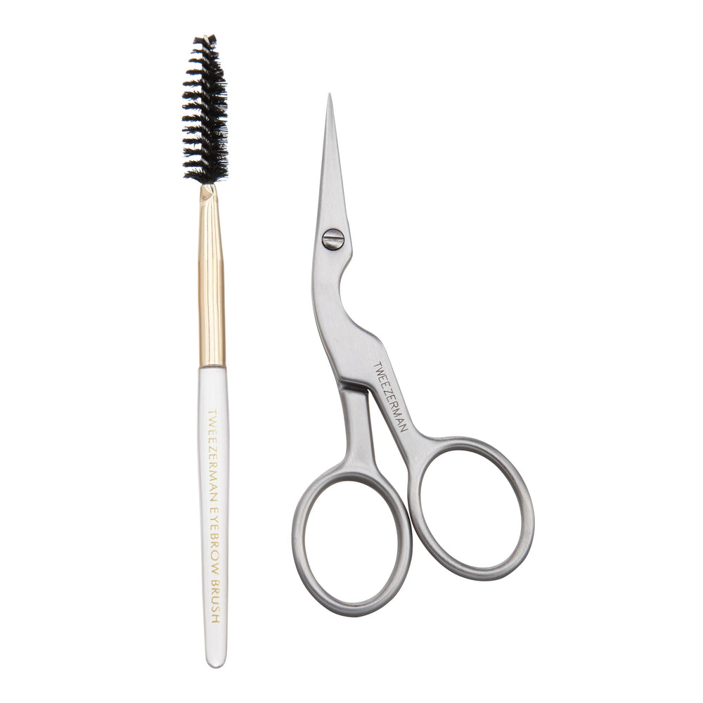 Tweezerman front view of scissors and brush showing compact travel-ready grooming