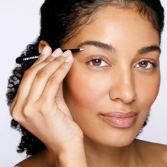 Tweezerman held in hand showing scale and comfortable control during grooming