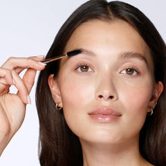 Tweezerman spoolie brush close-up arranging hairs for a natural shaped brow