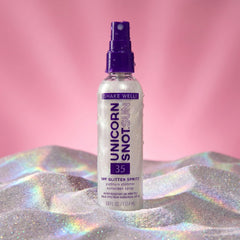 Unicorn Snot next to sunglasses showing travel size convenience and portability