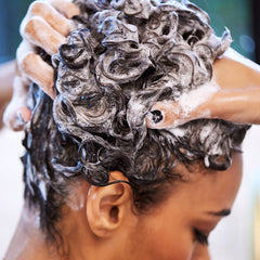 UNITE BOING shampoo on wet curly hair creating gentle cleansing lather