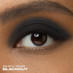 Urban Decay Blackout swatched on arm demonstrating bold payoff and buildable coverage benefit