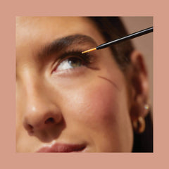 VEGAMOUR applying serum to upper lash line for gentle, effective use