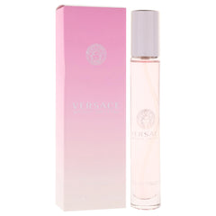Versace Bright Crystal bottle next to coin to show compact travel-friendly size