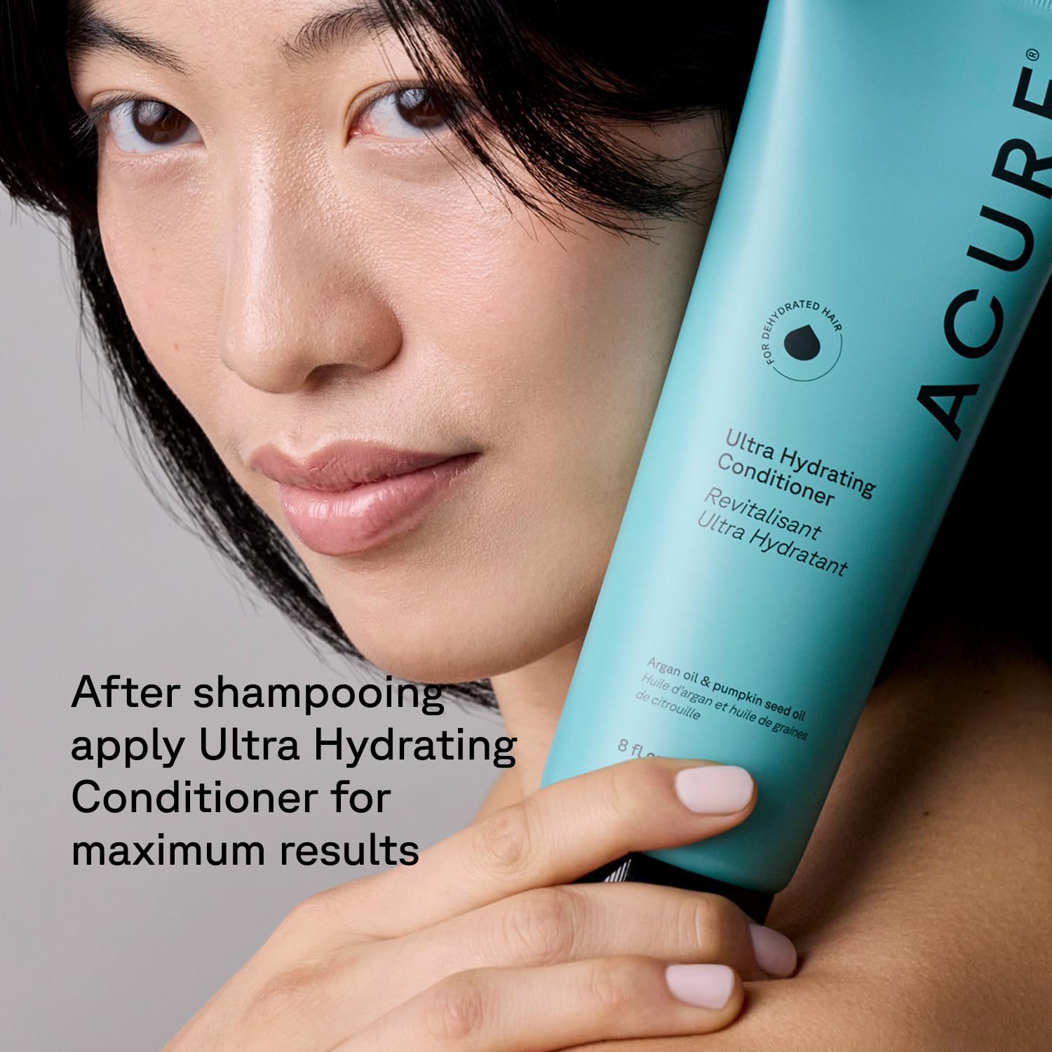 Acure bottle next to hand to show 8 fl oz size and travel-friendly convenience