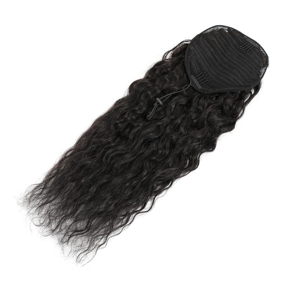 Adette hand holding ponytail next to ruler showing true 18-inch length and scale benefit