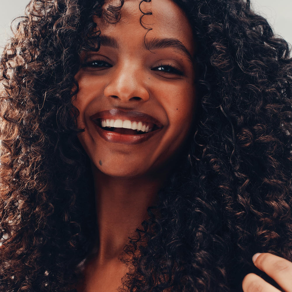AG Care before and after comparison illustrating reduced frizz and bounce
