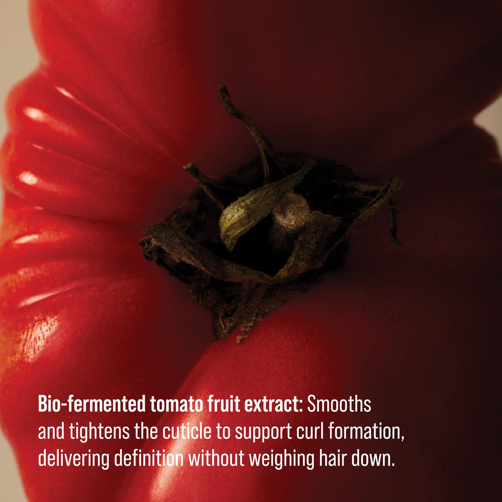 AG Care application in hand smoothing product through damp curls for control