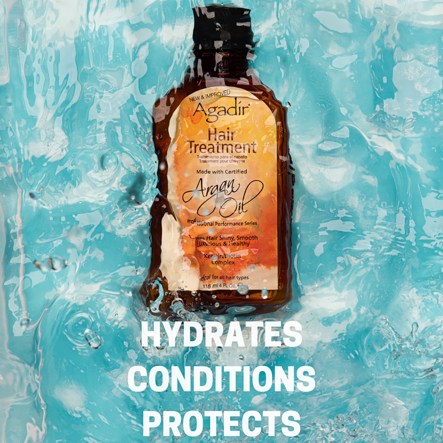 Agadir argan oil 4 fl oz held in hand to show compact travel-friendly size