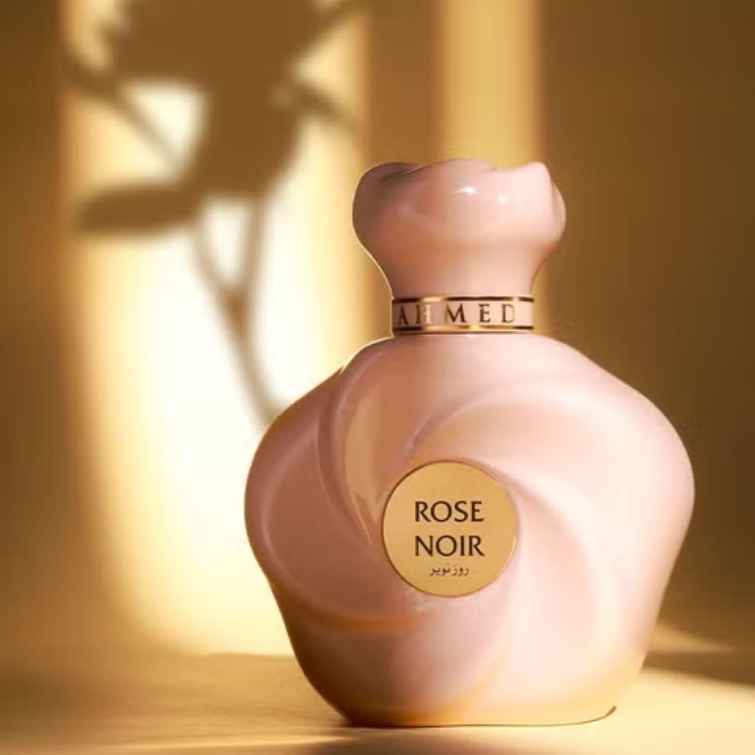 Ahmed Al Maghribi perfume being spritzed on wrist in evening setting, suggests long-lasting allure