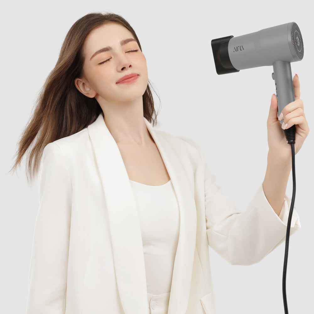 AINA held in hand showing scale and lightweight design for comfortable use