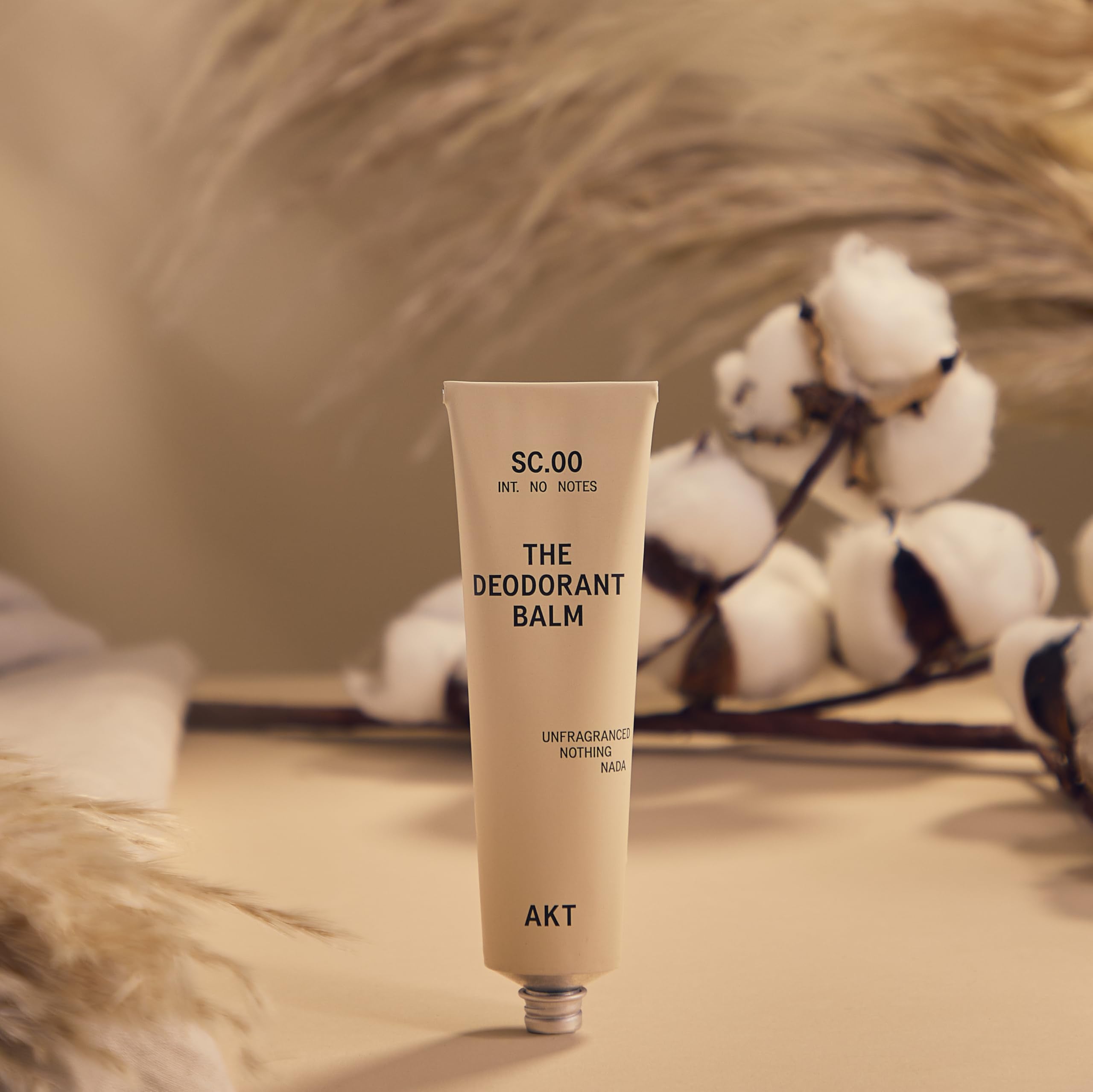 AKT open cap revealing smooth balm texture for easy application