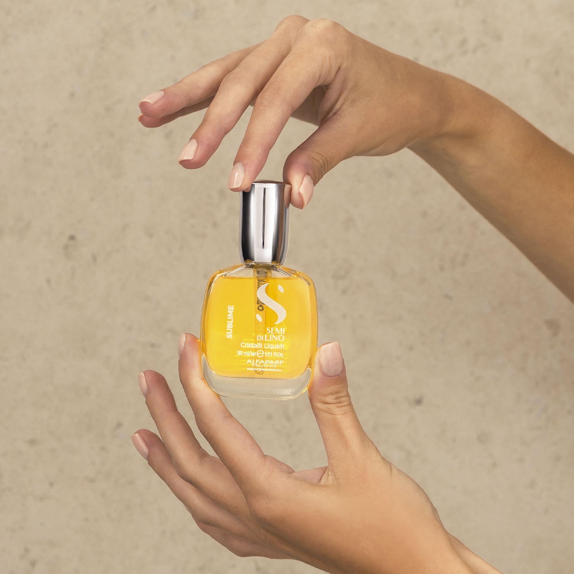 ALFAPARF MILANO applying serum to hands before styling for controlled distribution