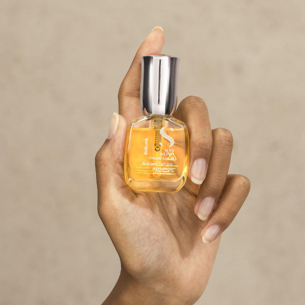 ALFAPARF MILANO 0.51 fl oz next to a phone showing compact travel-friendly size