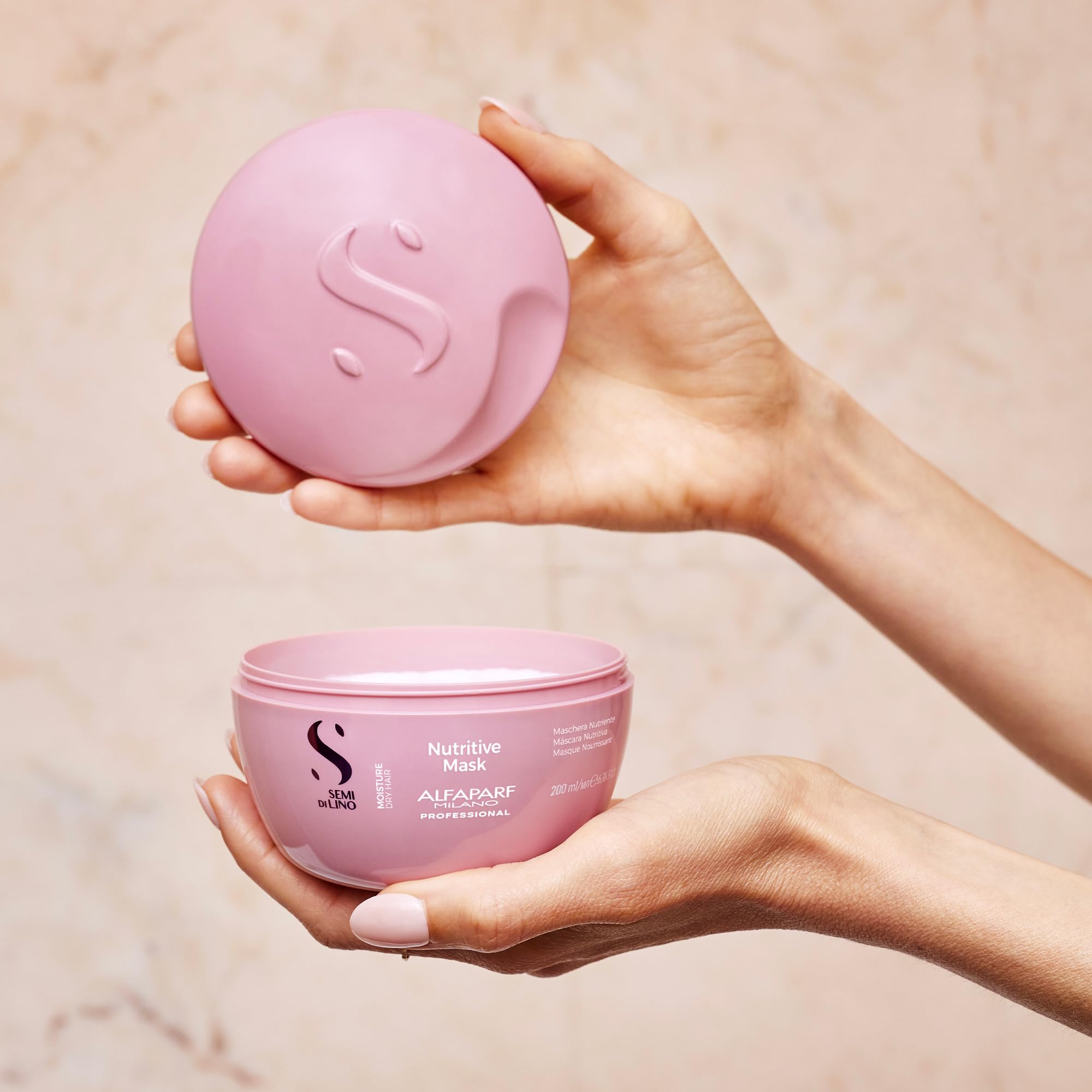 Alfaparf Milano products held in hand showing real size and travel convenience