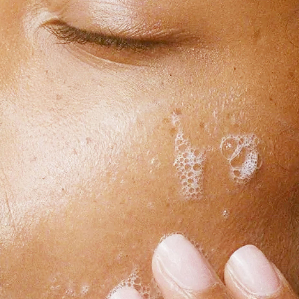Alpha Refreshing Face Wash held in hand showing 6 oz scale advantage