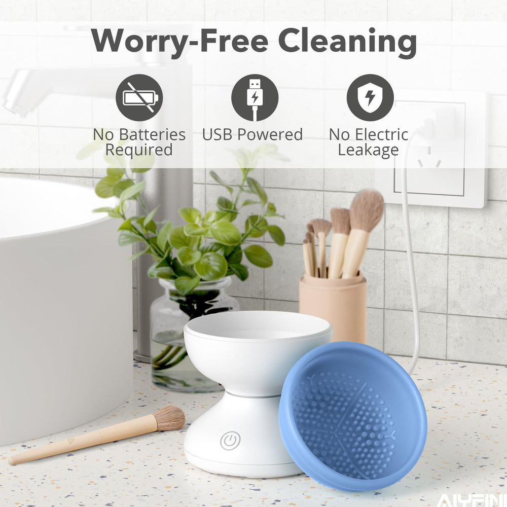 Alyfini held in hand for size comparison illustrating compact, travel-friendly brush cleaner