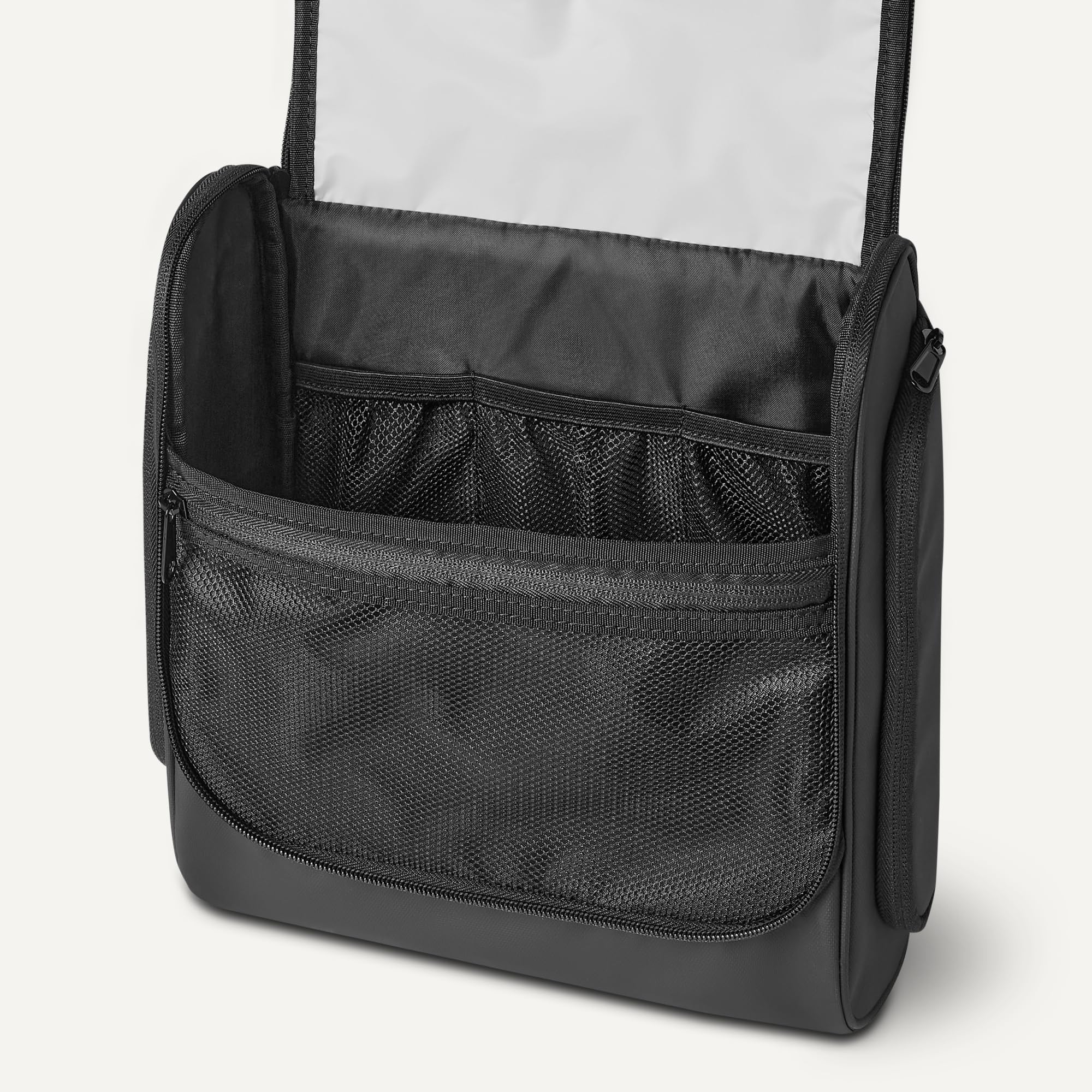 Amazon Essentials bag next to passport showing travel size and carry-on fit