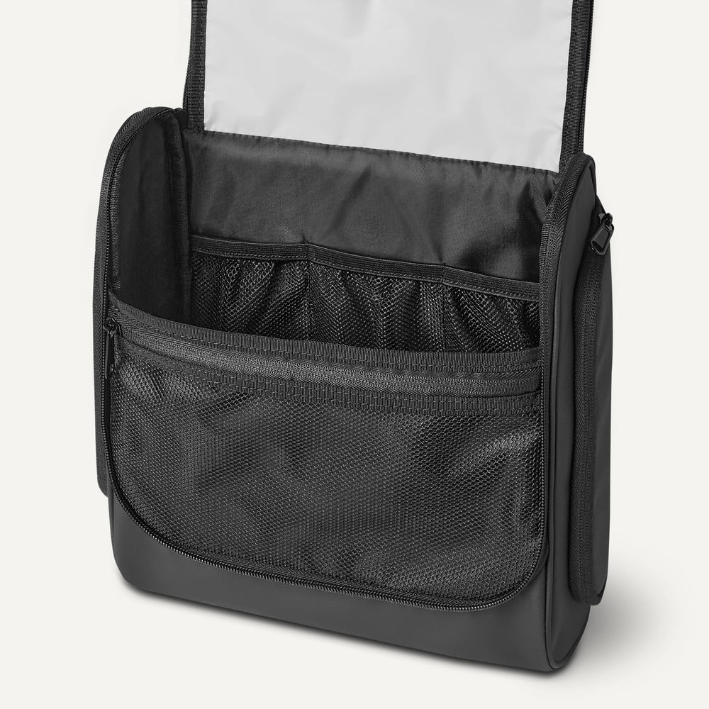 Amazon Essentials bag next to passport showing travel size and carry-on fit