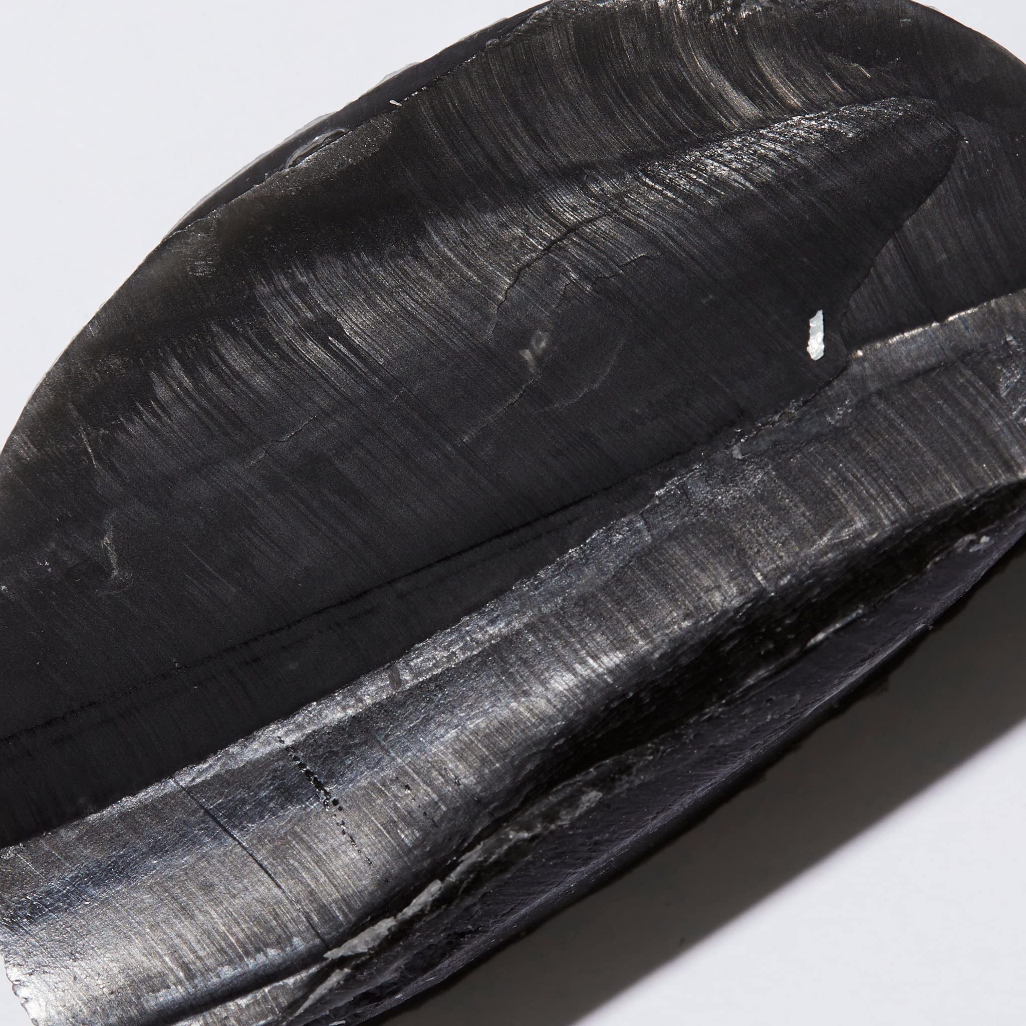 Ambi black soap bar on washcloth in use showing gentle cleansing and comfort benefit