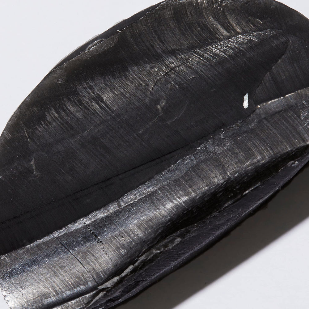 Ambi black soap bar on washcloth in use showing gentle cleansing and comfort benefit
