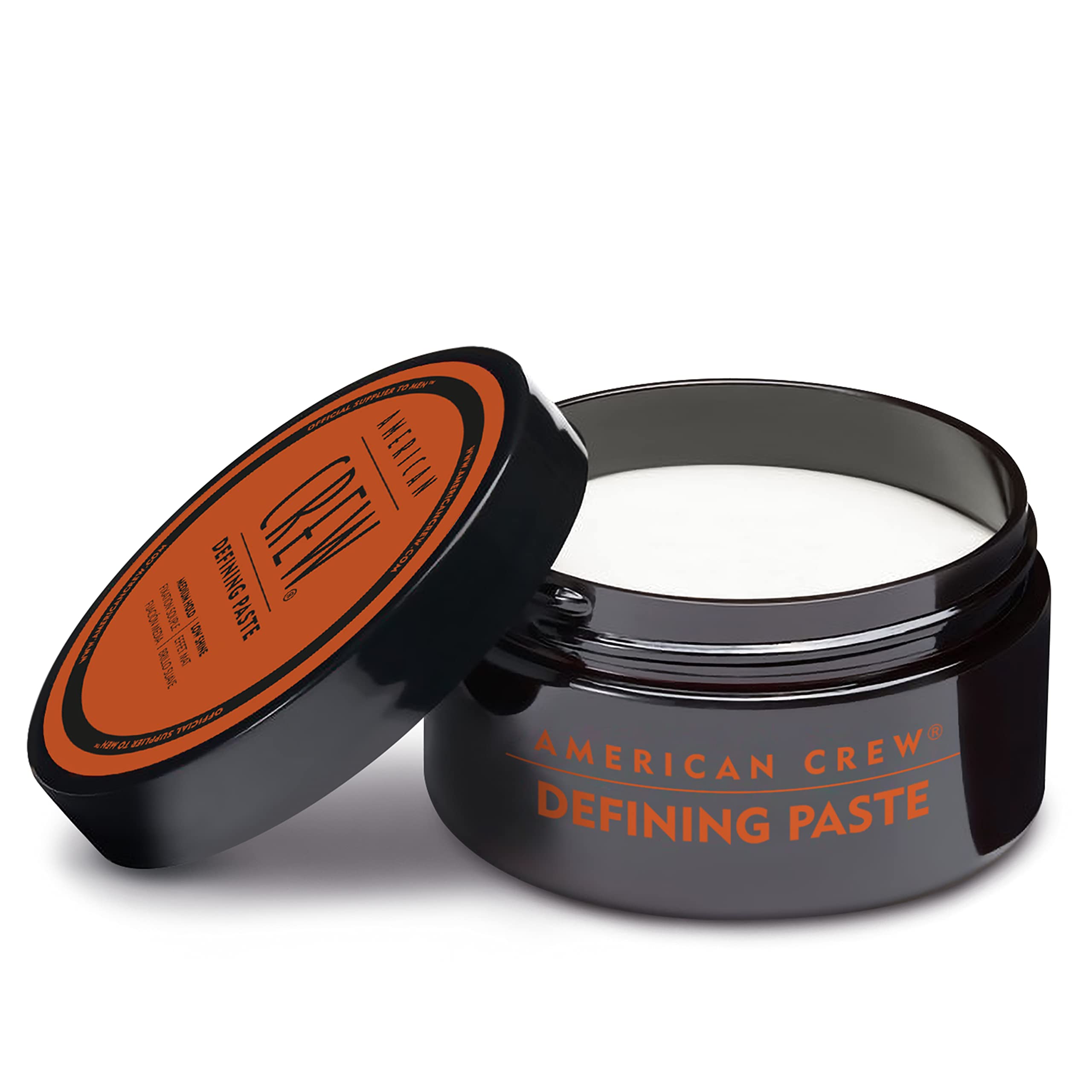 American Crew defining paste used by man styling at mirror showing everyday grooming benefit