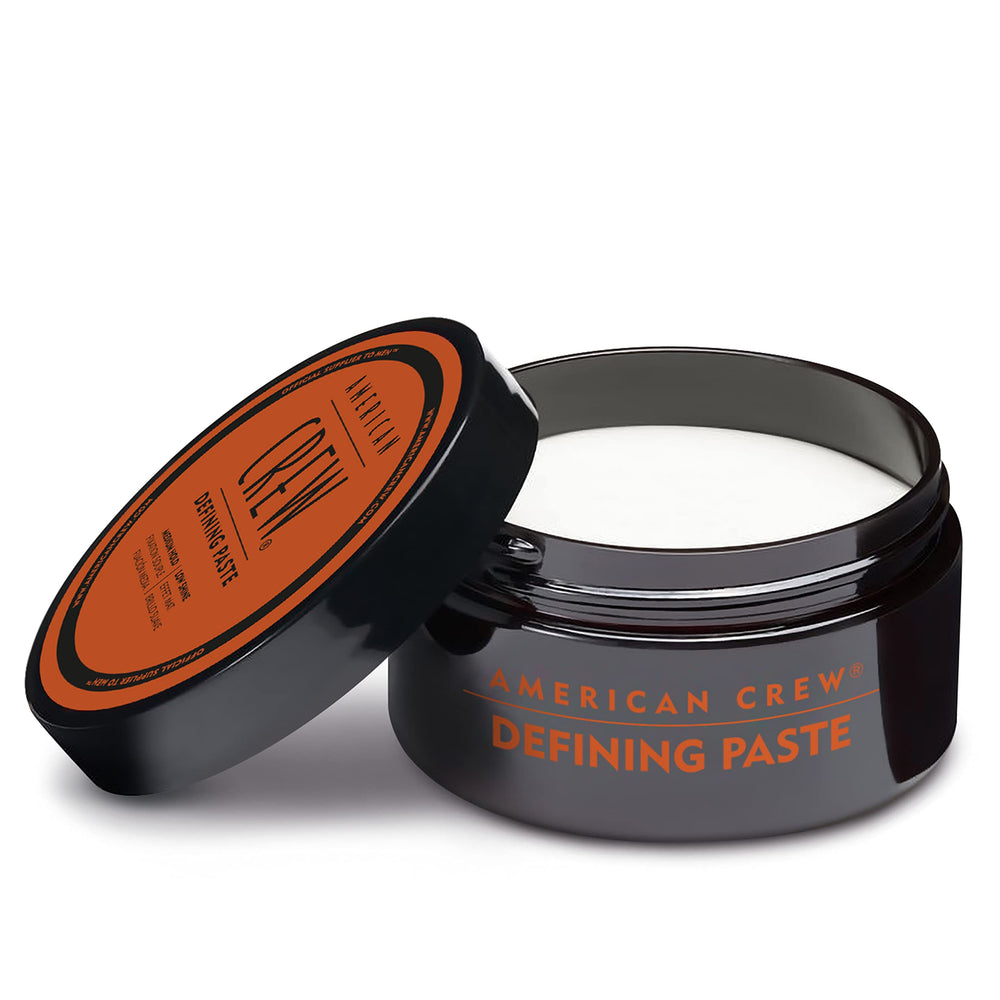 American Crew defining paste used by man styling at mirror showing everyday grooming benefit