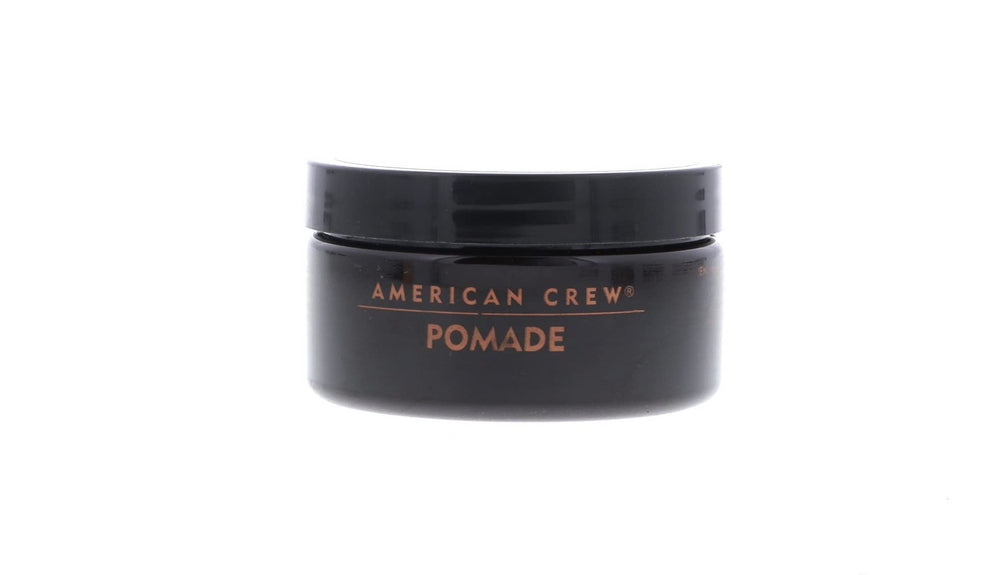 American Crew pomade on fingers ready to apply, aids precise styling
