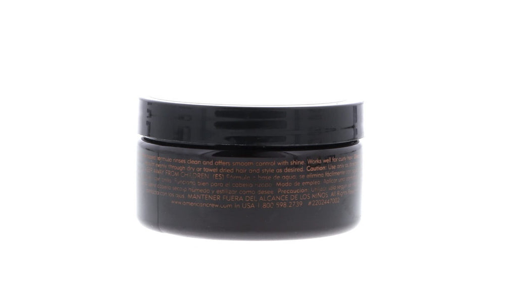 American Crew pomade next to hand for size comparison, ideal travel-friendly benefit