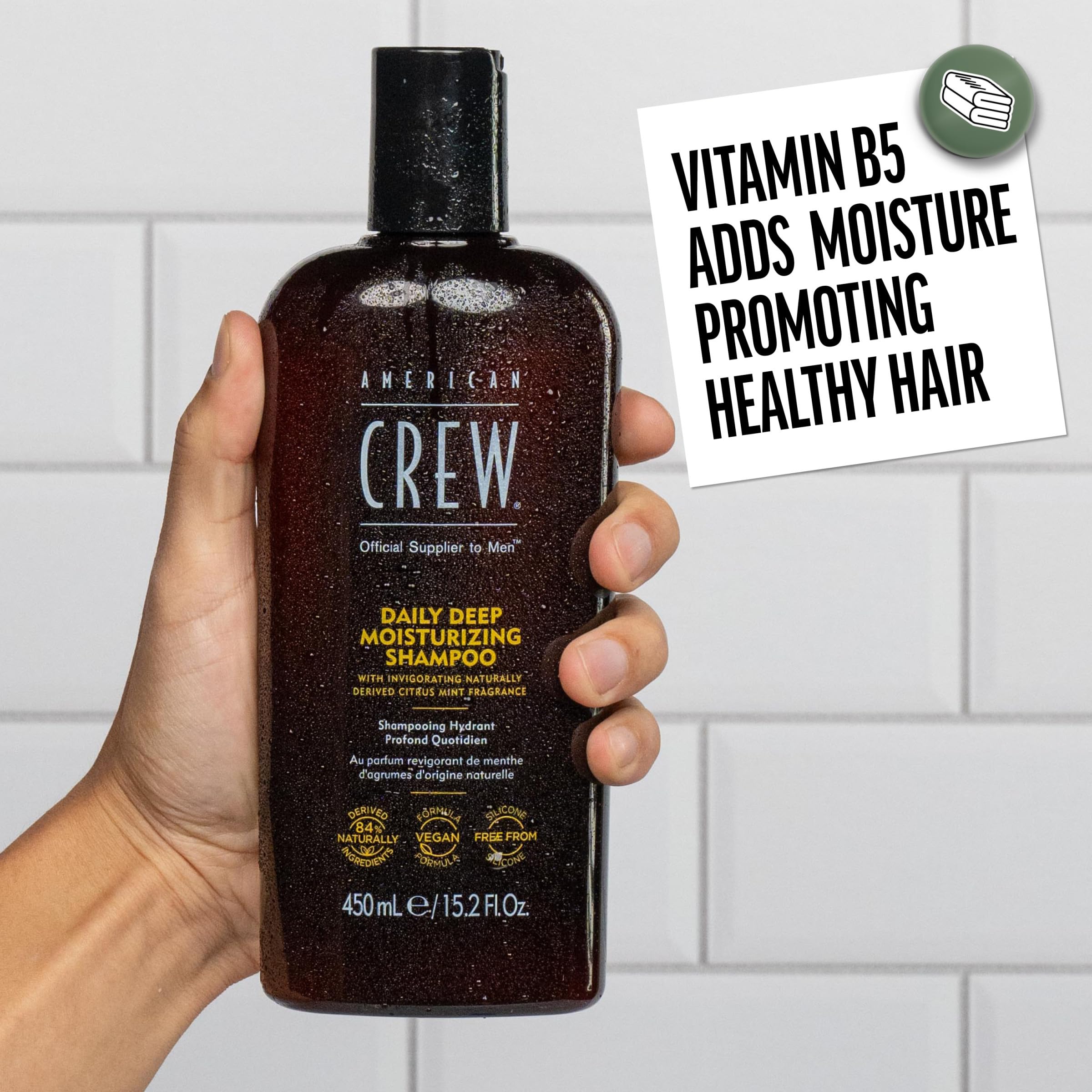 American Crew shampoo in hand during application demonstrating easy use and thorough rinse