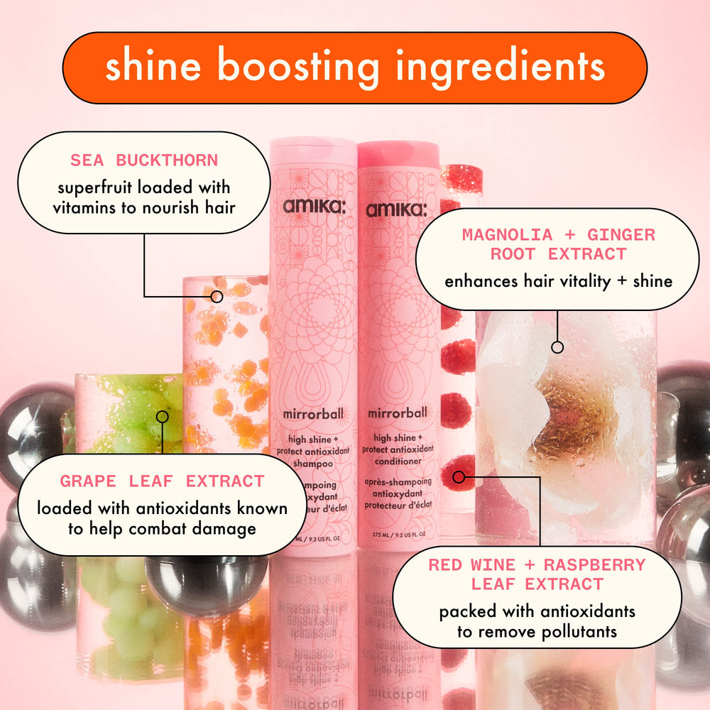 Hand holding Amika Mirrorball 500ml to show scale and ease of salon-size use