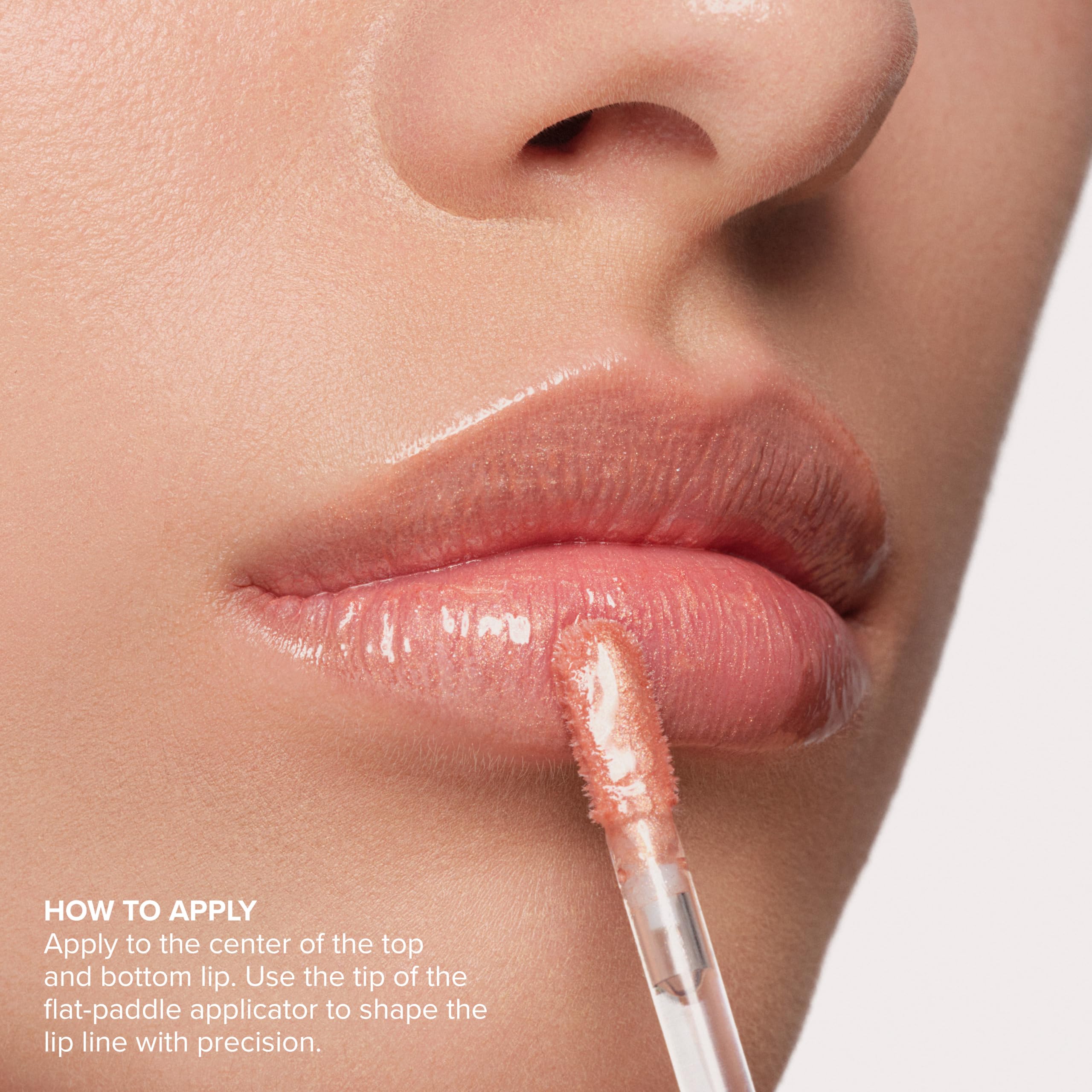 Anastasia Beverly Hills gloss beside a coin for size and scale, conveying travel-friendly packaging and portability