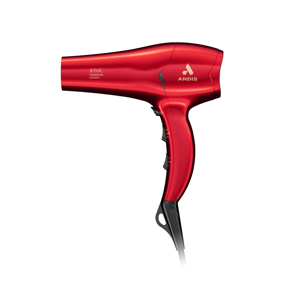 Andis dryer next to a hand for scale highlighting compact, travel-friendly size
