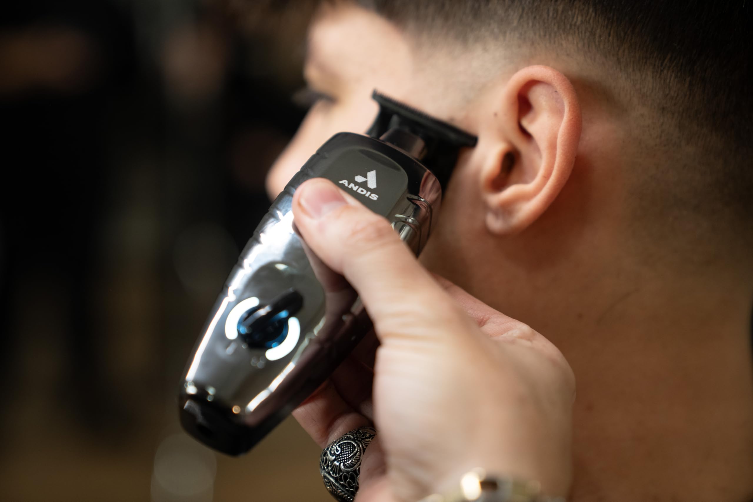 Andis GTX-EXO II black chrome close-up showing textured grip and ergonomic design benefit: comfortable control