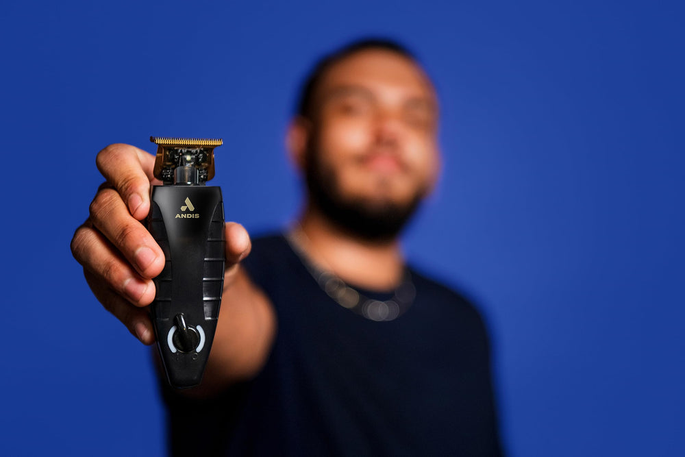 Andis GTX-EXO held in hand to show size and balance for comfortable professional use