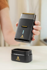 Andis shaver held in hand showing compact travel-friendly size benefit