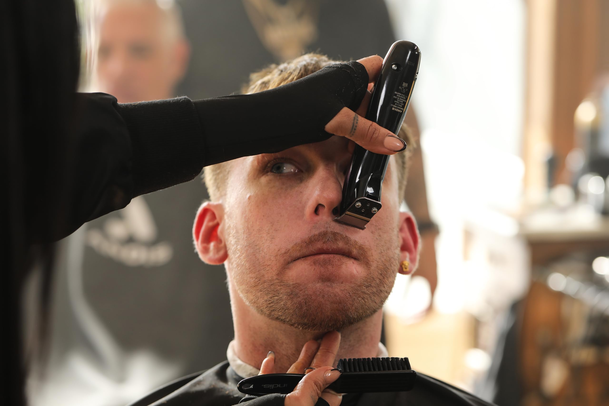 Andis Slimline Pro in barbershop setting showing professional finish benefit for styling