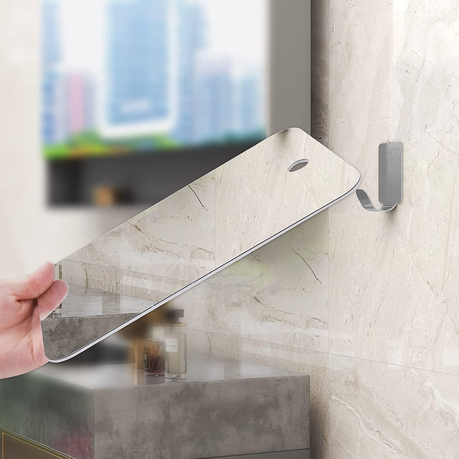 APHUIME mirror held by hand to show scale and large reflective area for full-face view