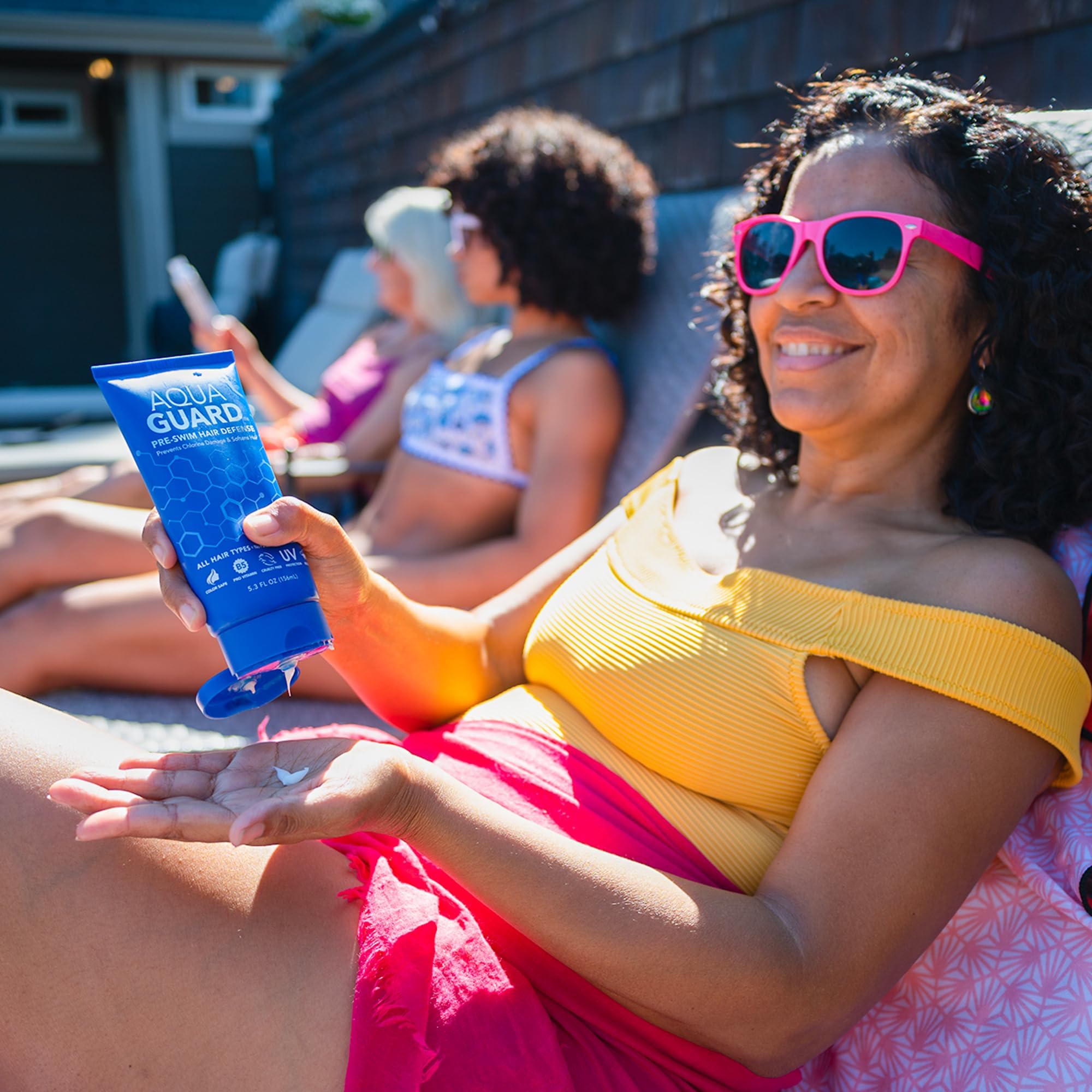 AQUA GUARD applied to damp hair pre-swim showing protective layer benefit