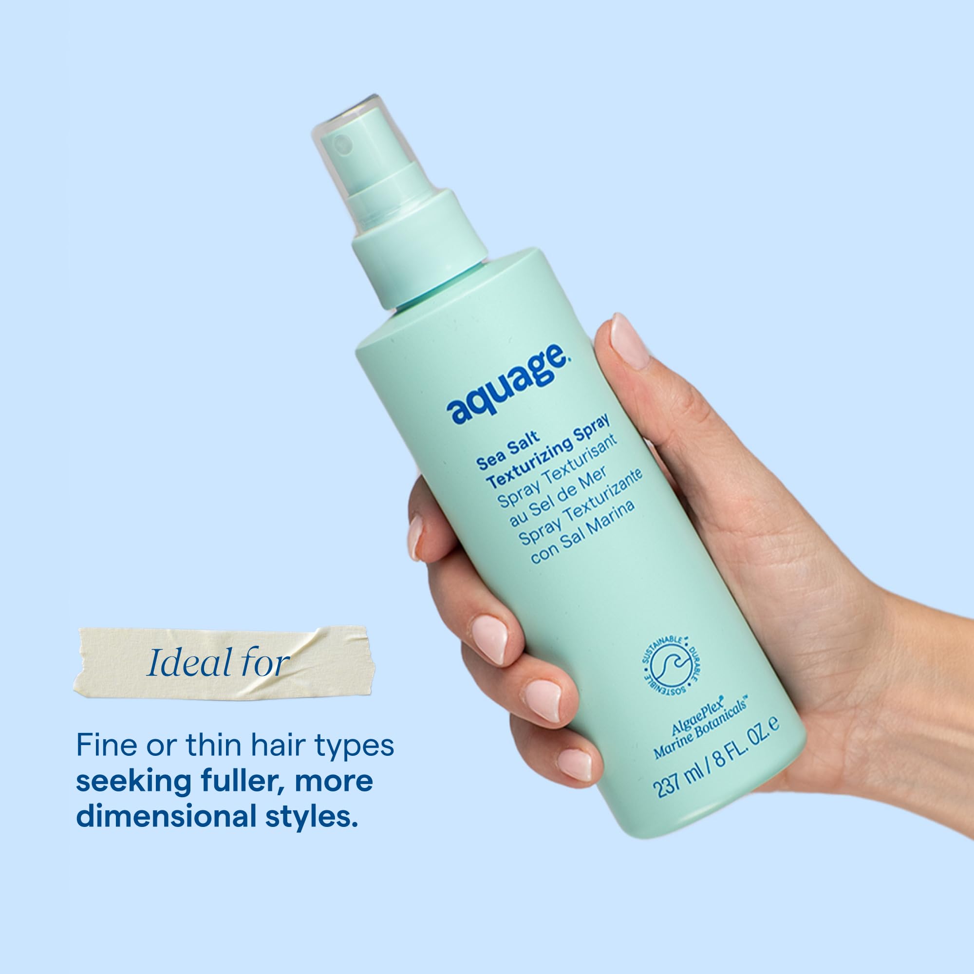 Aquage bottle staged with beach props conveying seaside texture and effortless style