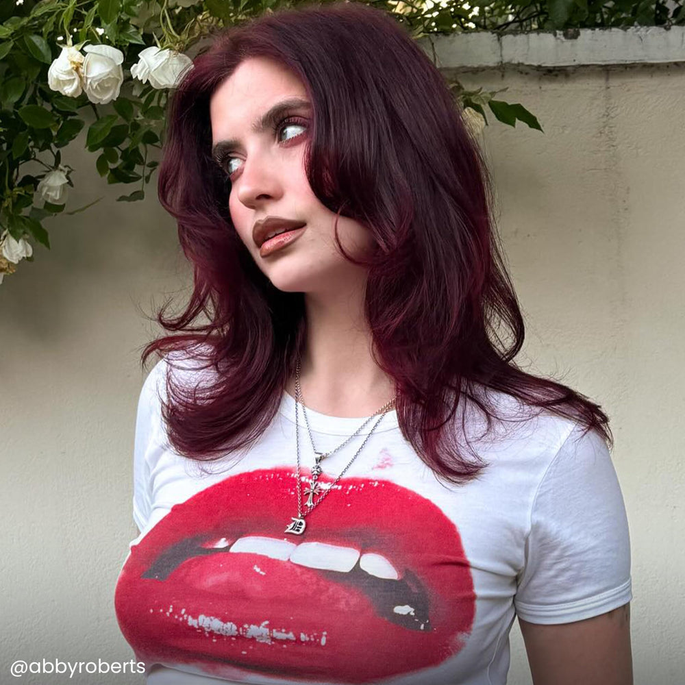 Hand applying ARCTIC FOX burgundy with brush to hair, demonstrates controlled, even color placement