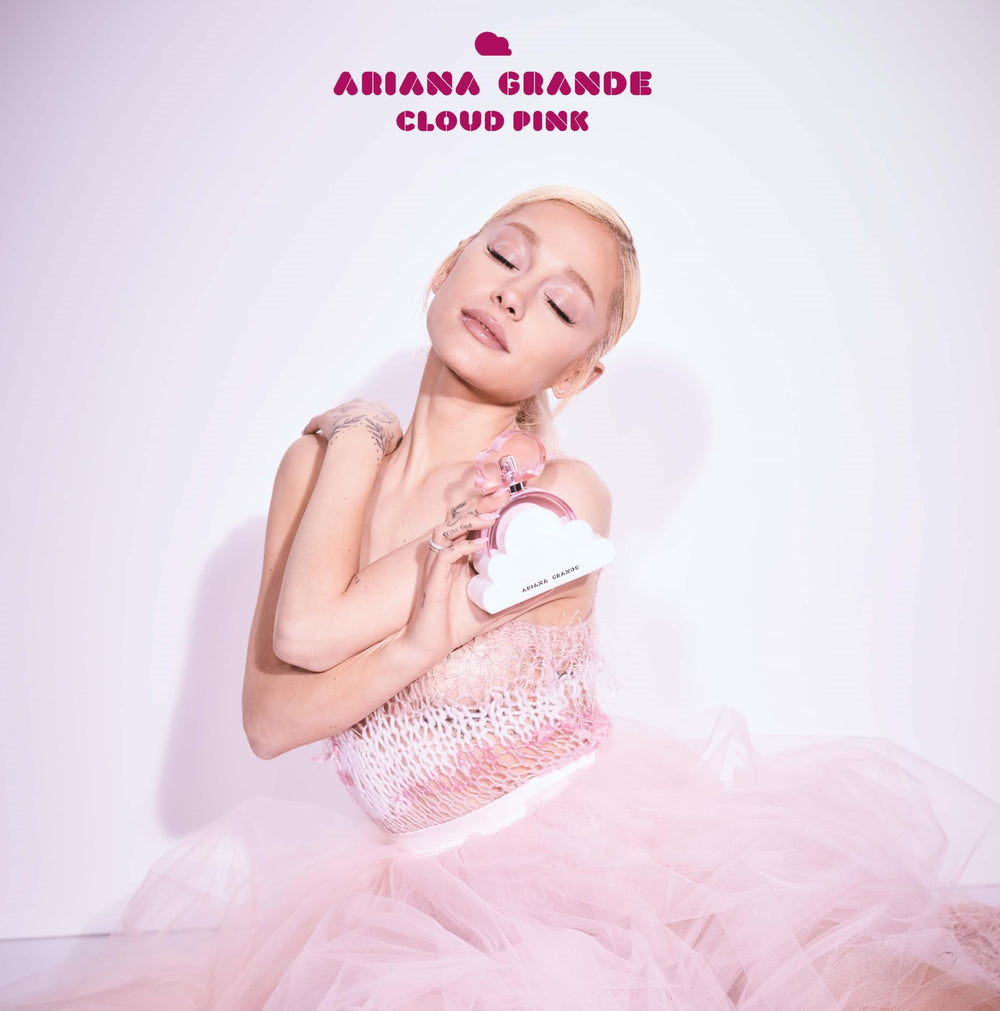 Person spraying Ariana Grande Cloud Pink on wrist, demonstrating easy everyday application