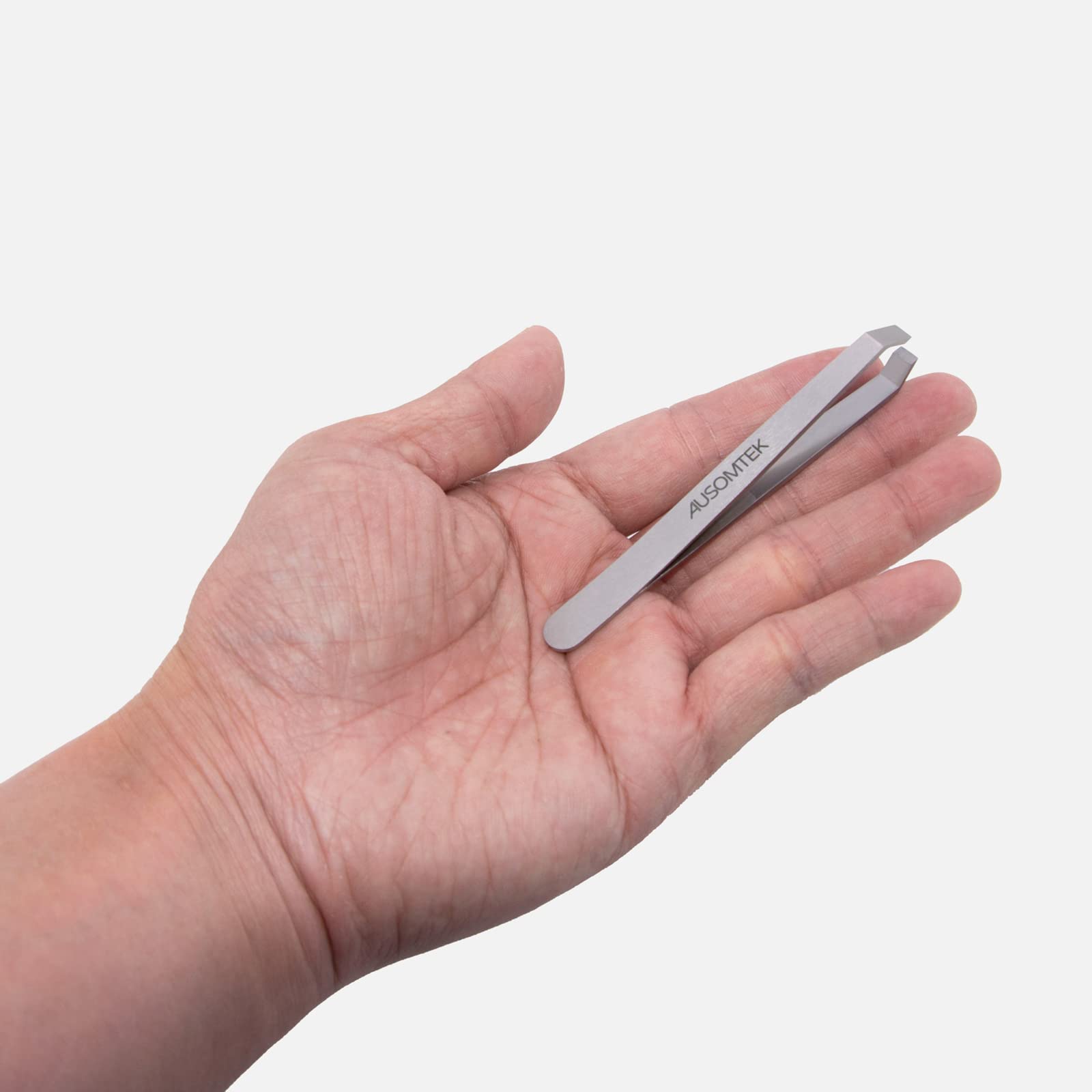 AUSOMTEK tweezers on bathroom vanity showing everyday use and tidy presentation